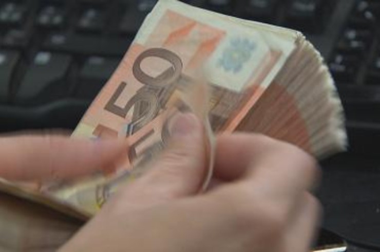 Impiegato di banca che conta i soldi - prestiti.com