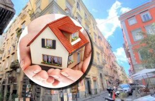 Una casetta e sullo sfondo uno scorcio di una città italiana